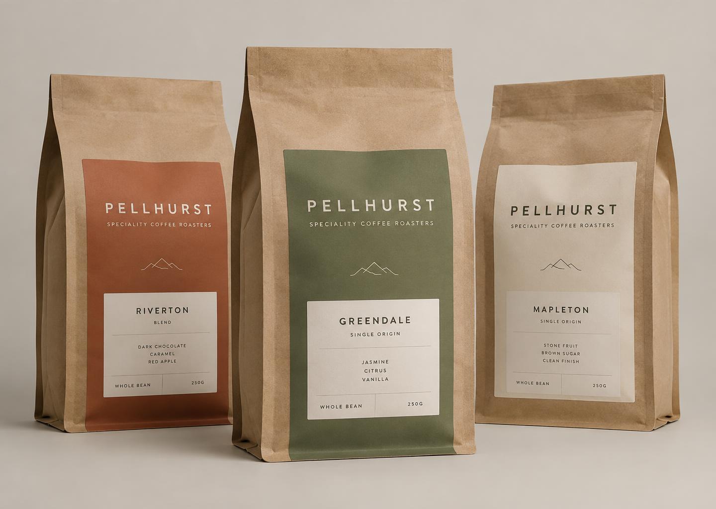 Three Pellhurst kraft coffee bags with terracotta, sage and cream labels